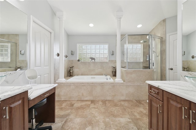full bath with a shower stall, a garden tub, vanity, and decorative columns