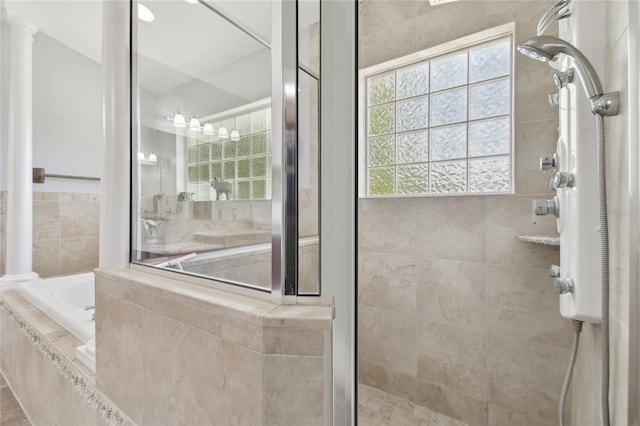 bathroom featuring a shower stall and a garden tub