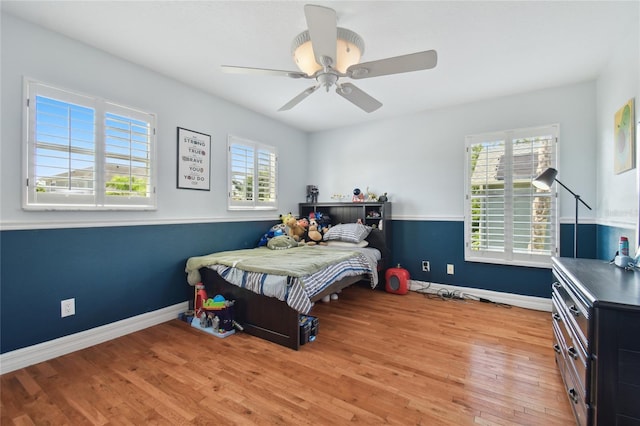 bedroom featuring baseboards, a ceiling fan, and wood finished floors