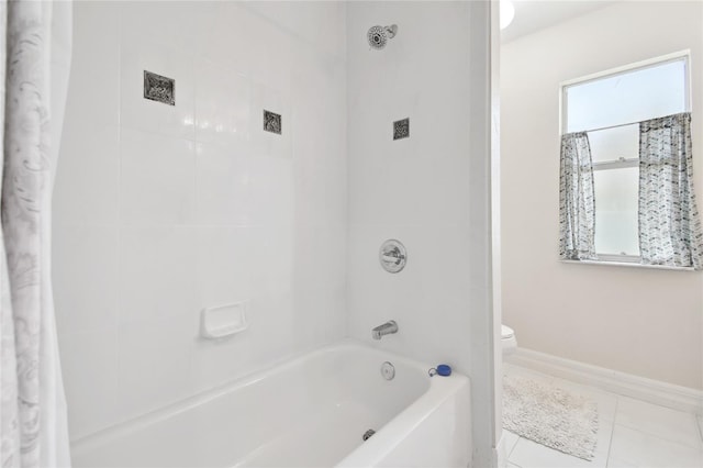 full bathroom featuring tile patterned flooring, baseboards, toilet, and shower / bathtub combination with curtain