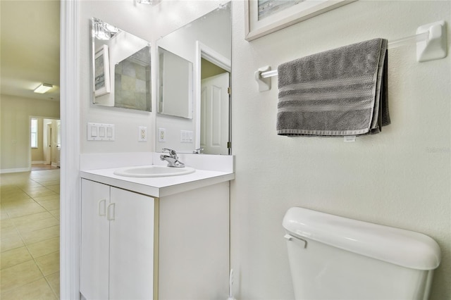bathroom featuring vanity, toilet, and tile patterned flooring