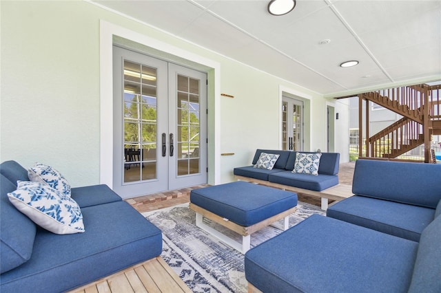 living room featuring stairway, a healthy amount of sunlight, parquet flooring, and french doors