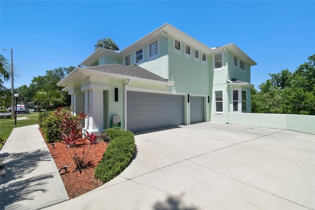 view of home's exterior featuring a garage, concrete driveway, and stucco siding