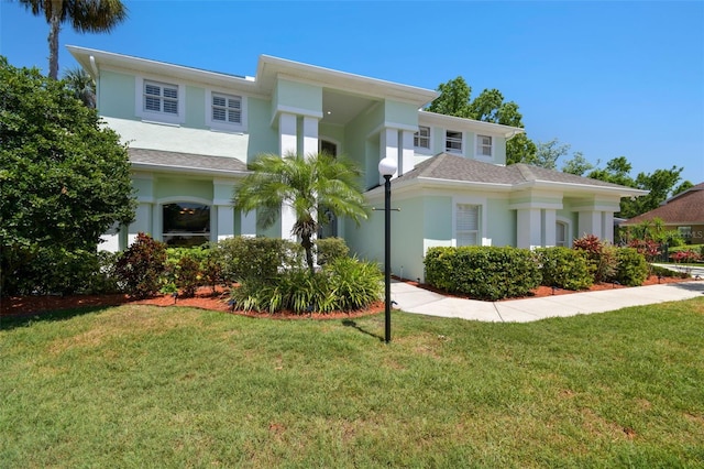 view of front of property featuring a front lawn and stucco siding