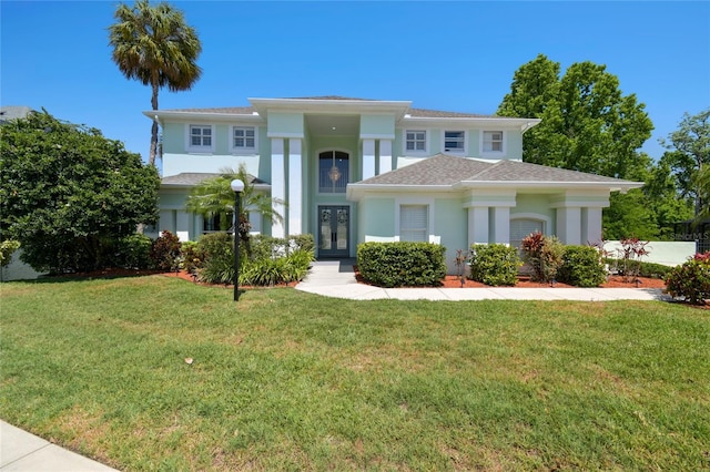 view of front of property featuring french doors, a front yard, and stucco siding