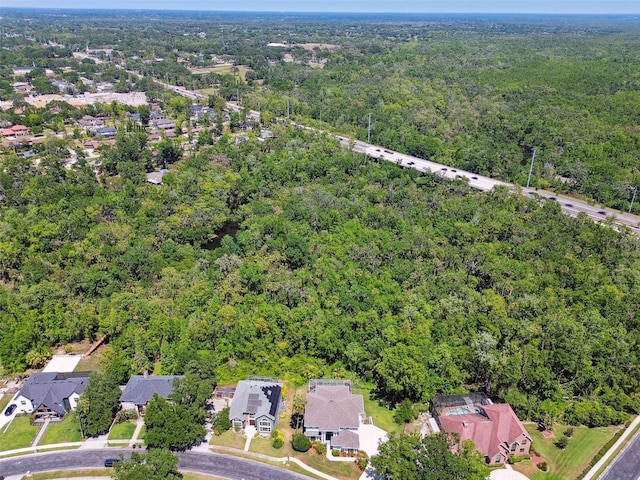 birds eye view of property with a forest view