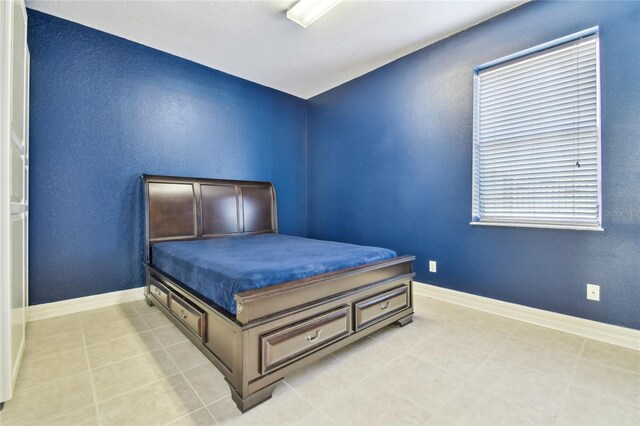 13310 Waterford Run Dr, Riverview, FL 33569 - bedroom featuring baseboards and light tile patterned flooring