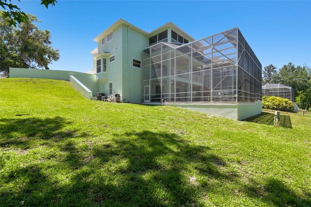 13310 Waterford Run Dr, Riverview, FL 33569 - back of house with a lawn, stucco siding, and a lanai