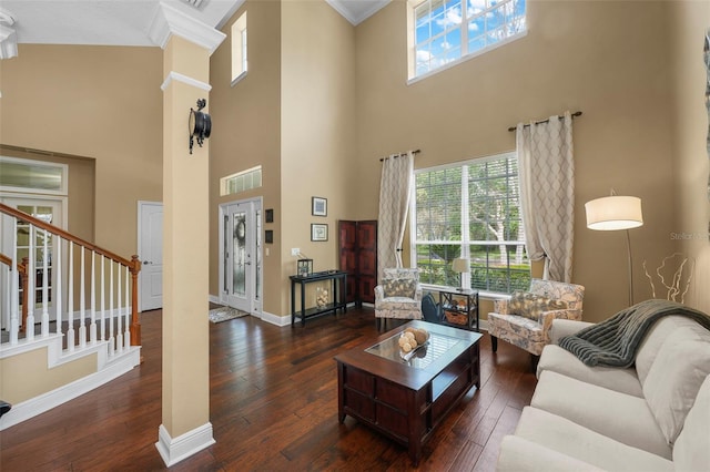 living area with wood-type flooring, ornamental molding, baseboards, and stairway