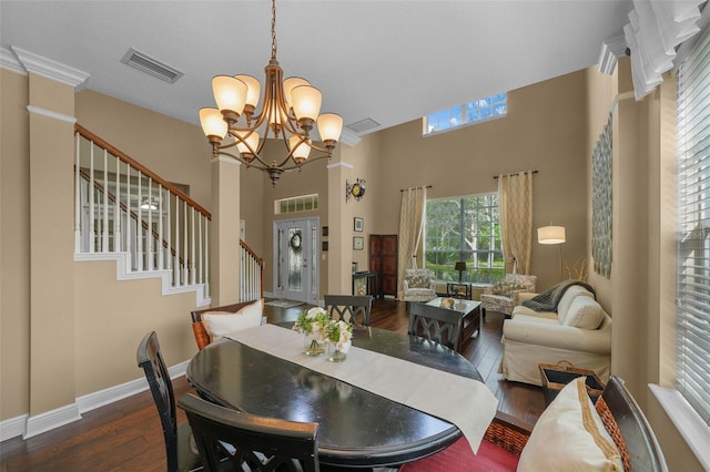 dining area with an inviting chandelier, wood finished floors, baseboards, and visible vents