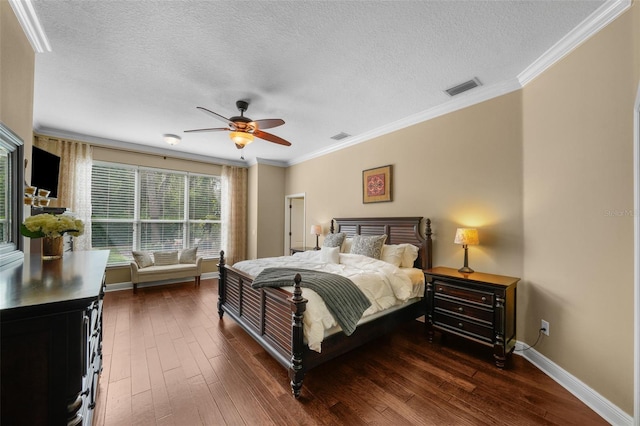 bedroom featuring baseboards, dark wood-style flooring, a textured ceiling, and visible vents
