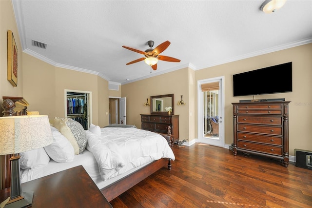 bedroom featuring baseboards, visible vents, crown molding, and wood-type flooring