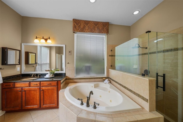 bathroom with a shower stall, tile patterned floors, vanity, and a jetted tub