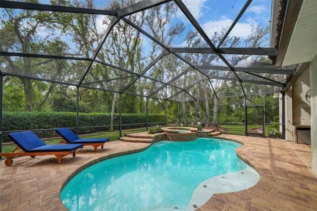 view of swimming pool featuring a pool with connected hot tub, a lanai, and a patio area