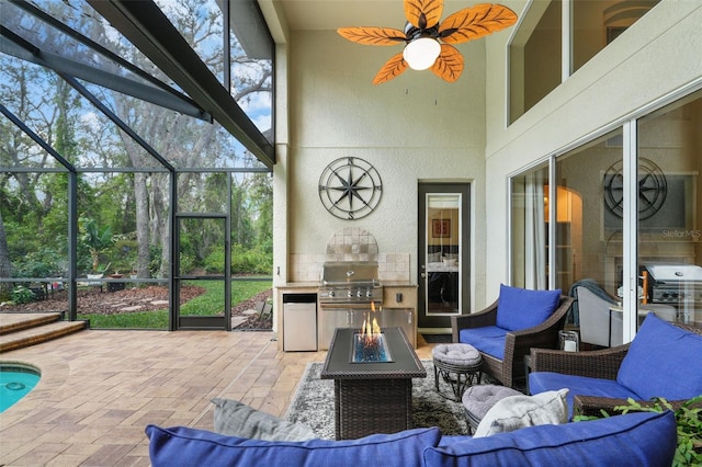 view of patio / terrace featuring grilling area, a lanai, area for grilling, and an outdoor living space with a fire pit