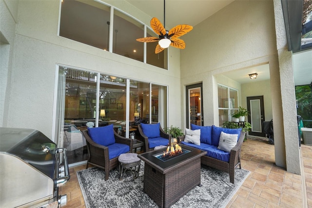 view of patio featuring area for grilling and an outdoor living space with a fire pit