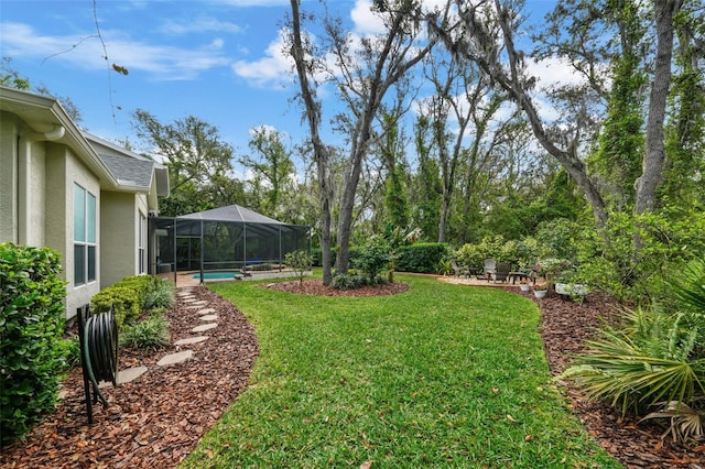 view of yard with an outdoor pool, glass enclosure, and a patio