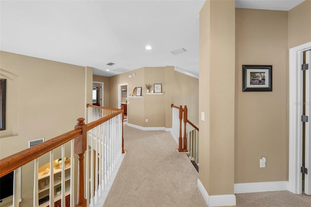 hallway featuring carpet floors, an upstairs landing, baseboards, and recessed lighting