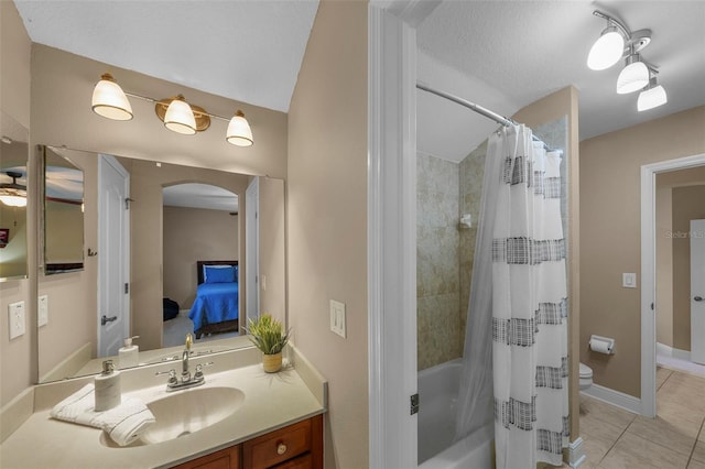 full bath with connected bathroom, toilet, vanity, tile patterned flooring, and shower / bath combination with curtain