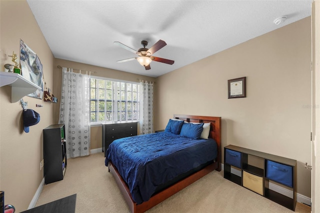 carpeted bedroom with baseboards and a ceiling fan