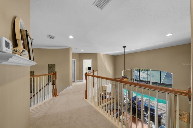 hallway with baseboards, an upstairs landing, recessed lighting, and carpet