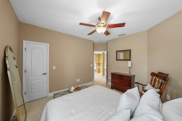 bedroom featuring light colored carpet, visible vents, ceiling fan, and baseboards