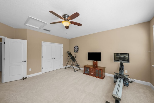 workout area with attic access, baseboards, visible vents, ceiling fan, and carpet