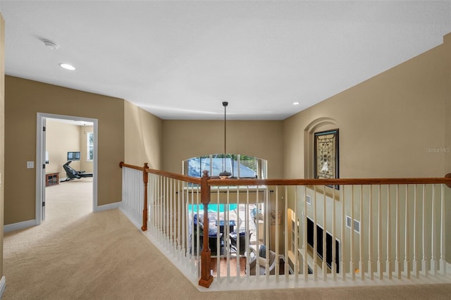 hallway featuring baseboards, carpet floors, a wealth of natural light, and recessed lighting