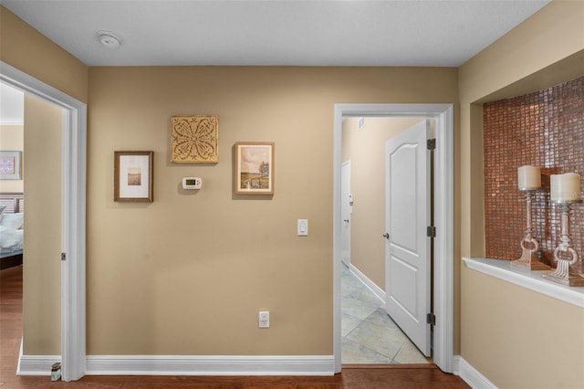 hall featuring baseboards