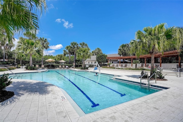 pool with a patio and a pergola