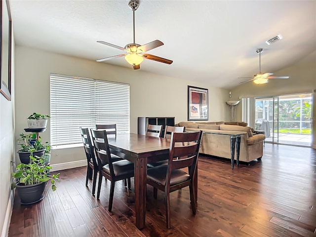 dining space featuring vaulted ceiling, baseboards, visible vents, ceiling fan, and dark wood-type flooring