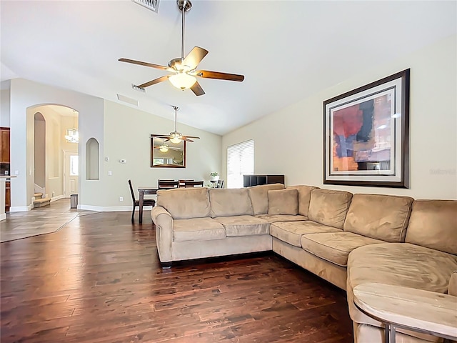 living area featuring arched walkways, visible vents, lofted ceiling, ceiling fan, and dark wood-type flooring