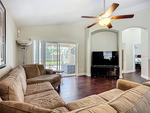 living room with vaulted ceiling, wood finished floors, ceiling fan, arched walkways, and baseboards