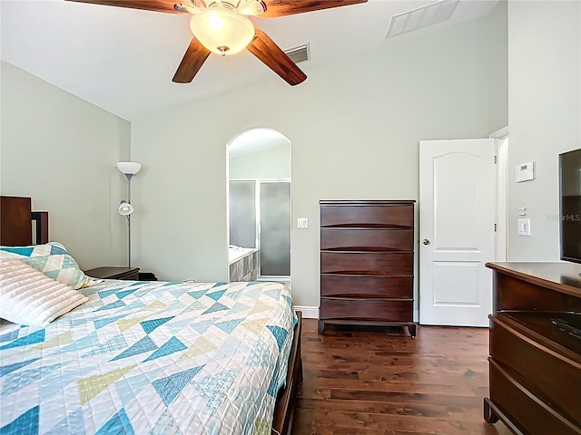 bedroom featuring a ceiling fan, arched walkways, visible vents, and dark wood-style floors