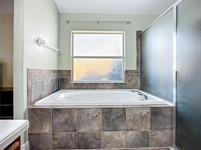 full bathroom featuring a bath and a shower stall