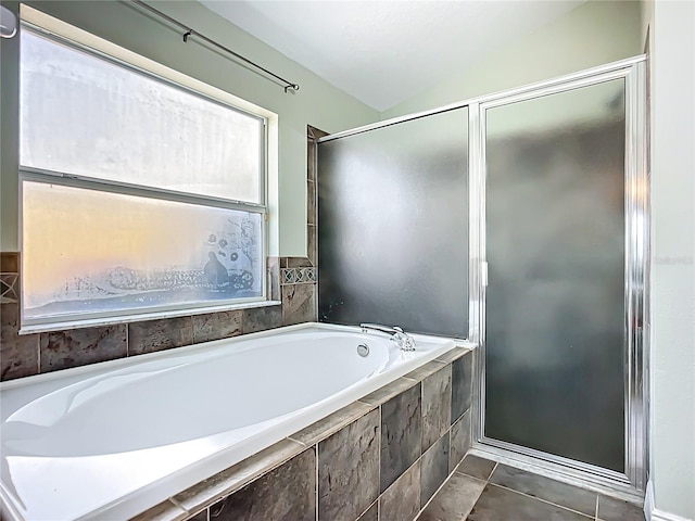 bathroom featuring a bath and tile patterned flooring