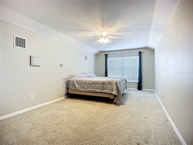 bedroom featuring lofted ceiling, visible vents, a ceiling fan, baseboards, and light colored carpet