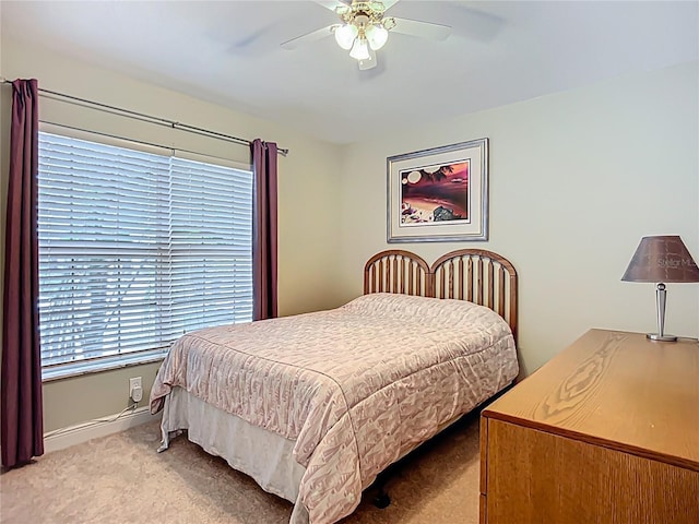bedroom with carpet flooring, baseboards, and a ceiling fan