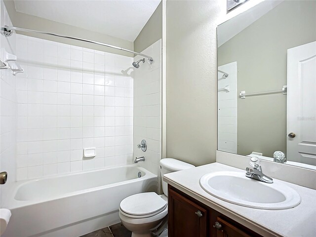 bathroom with shower / bathtub combination, vanity, and toilet