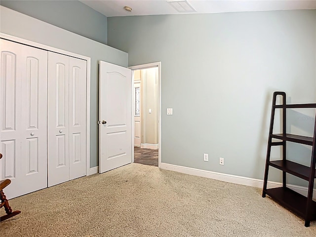 unfurnished bedroom featuring baseboards, visible vents, and a closet