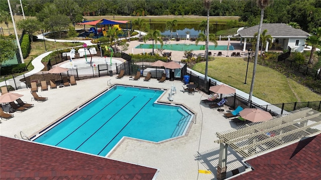pool featuring fence, a yard, and a patio