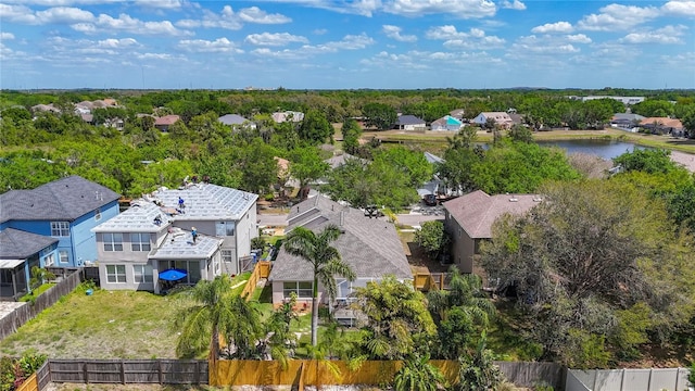 birds eye view of property with a water view and a residential view