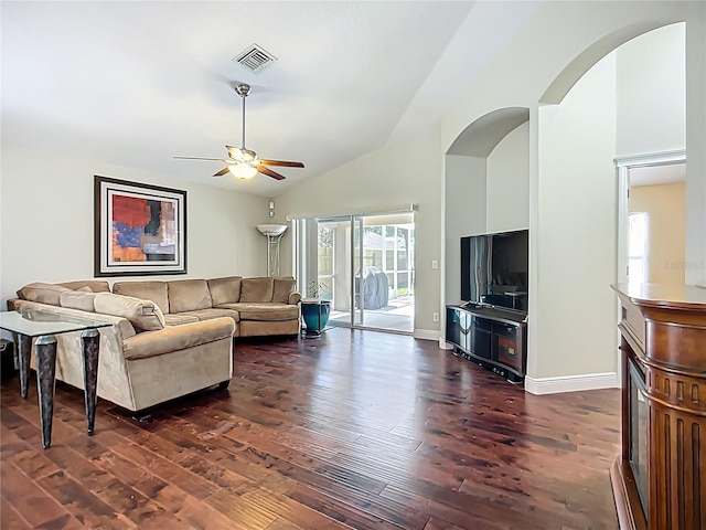 living room featuring ceiling fan, visible vents, baseboards, and dark wood-style flooring