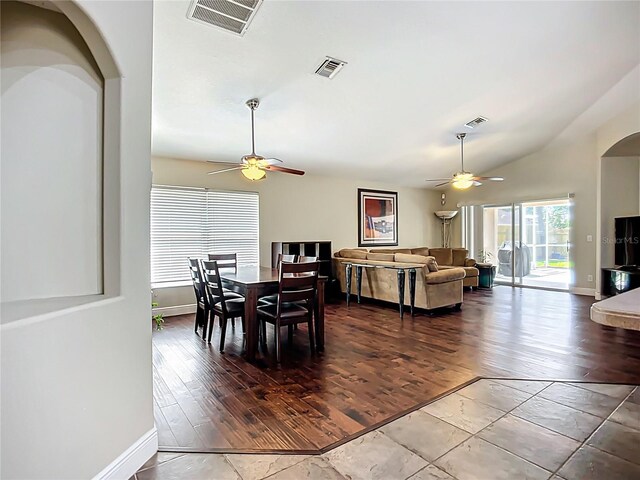 dining space with lofted ceiling, visible vents, and ceiling fan