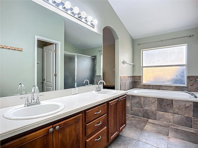 bathroom with vaulted ceiling, a sink, and a stall shower