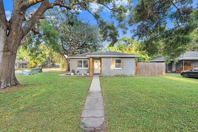 2001 E Idlewild Ave, Tampa, FL 33610 - view of front of property with fence and a front yard
