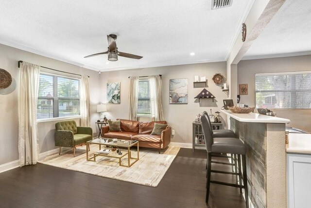 2001 E Idlewild Ave, Tampa, FL 33610 - living room featuring visible vents, baseboards, ceiling fan, wood finished floors, and ornamental molding