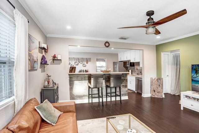 2001 E Idlewild Ave, Tampa, FL 33610 - living area with dark wood-style flooring, visible vents, crown molding, and a ceiling fan