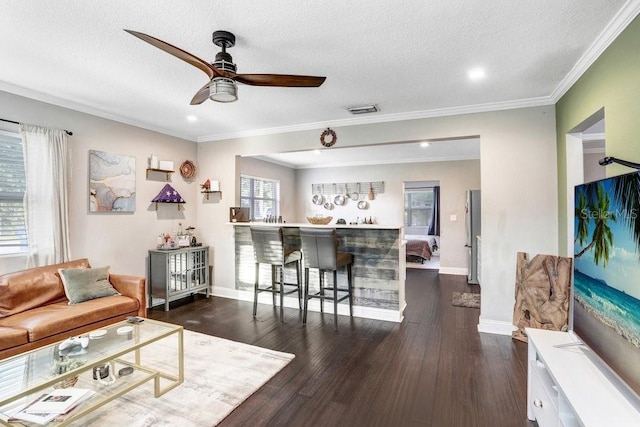 2001 E Idlewild Ave, Tampa, FL 33610 - living room with dark wood-style floors, visible vents, a ceiling fan, and ornamental molding