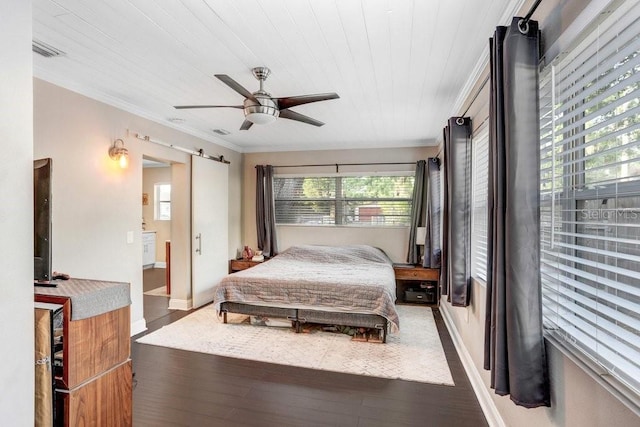 2001 E Idlewild Ave, Tampa, FL 33610 - bedroom featuring ornamental molding, baseboards, a barn door, visible vents, and wood finished floors